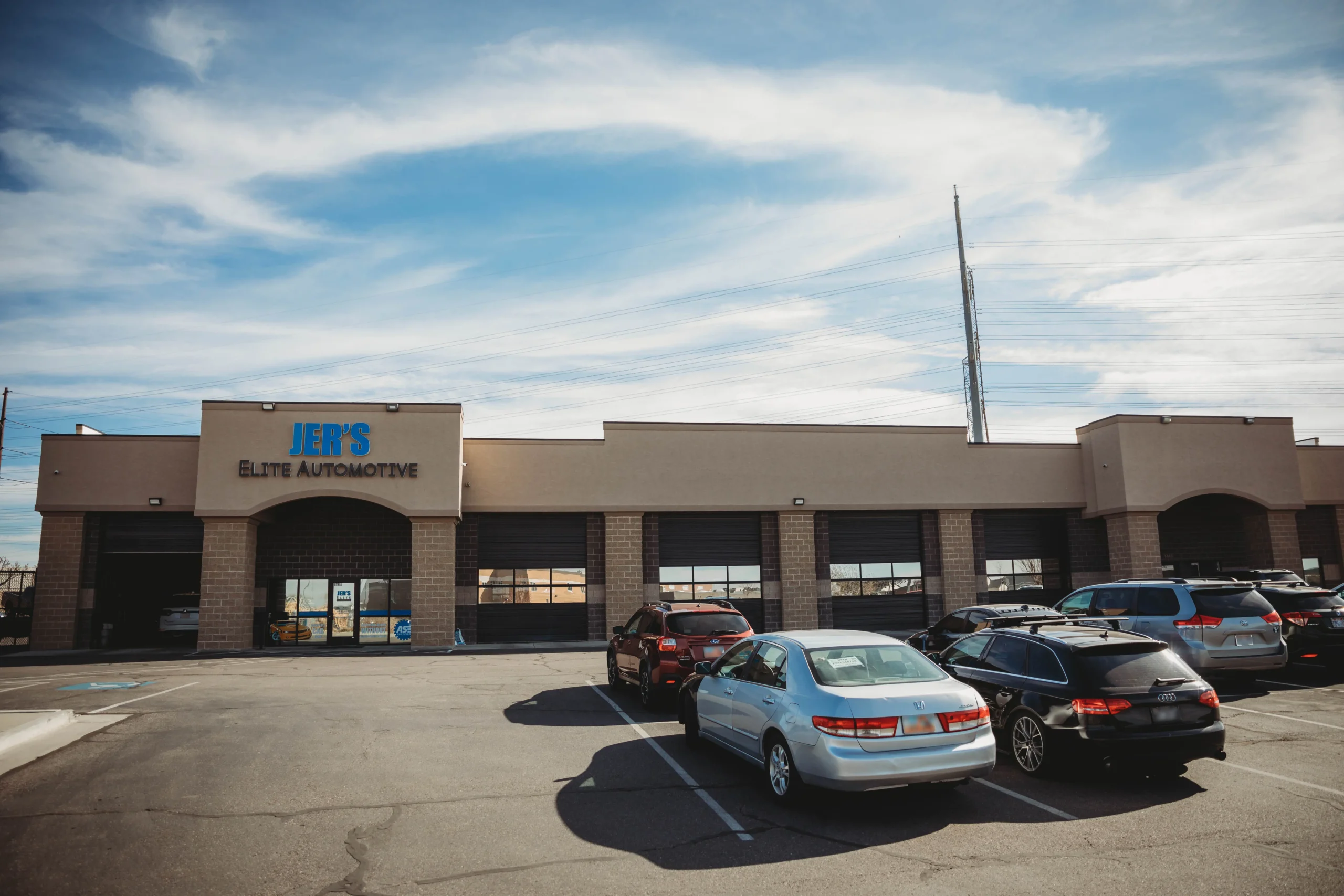 Exterior of Jer’s Elite Automotive in Syracuse, Utah, showcasing a professional mechanic shop with multiple service bays, offering top-quality auto repair and maintenance in Davis County.