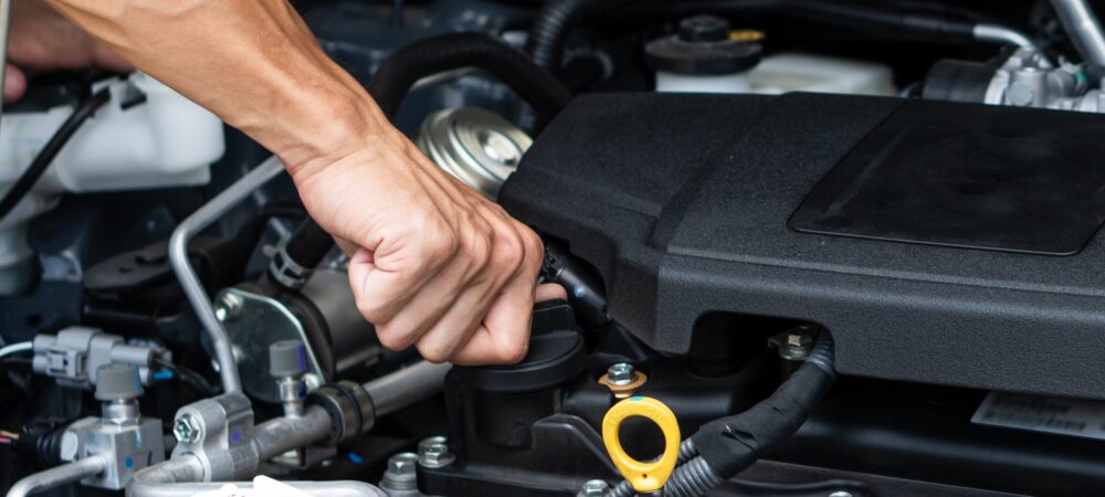 hand-of-car-machanic-checking-oil-and-oil-change-in-car-engine-and-car-maintenance-in-garage-